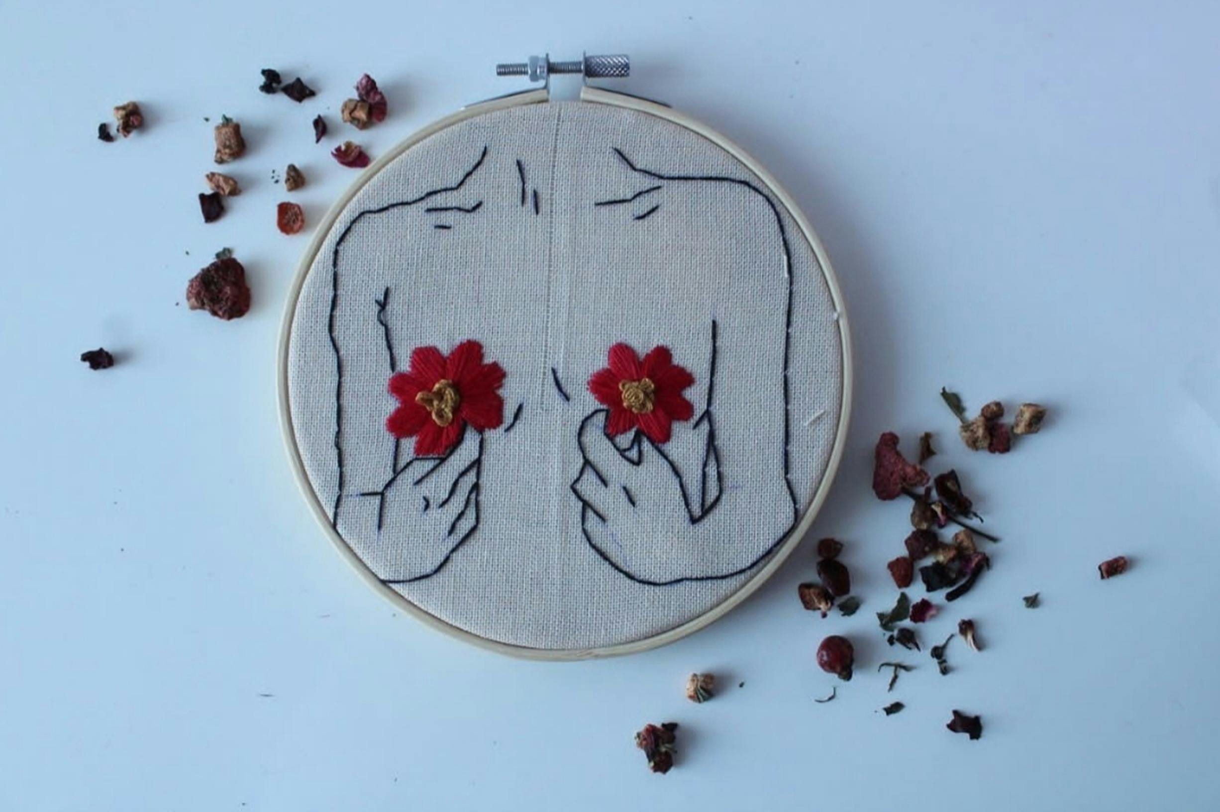 Unique embroidery art depicting a floral design in a hoop.